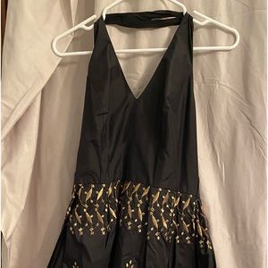 Black with gold stitching halter dress. Full skirt with taffeta underlay.